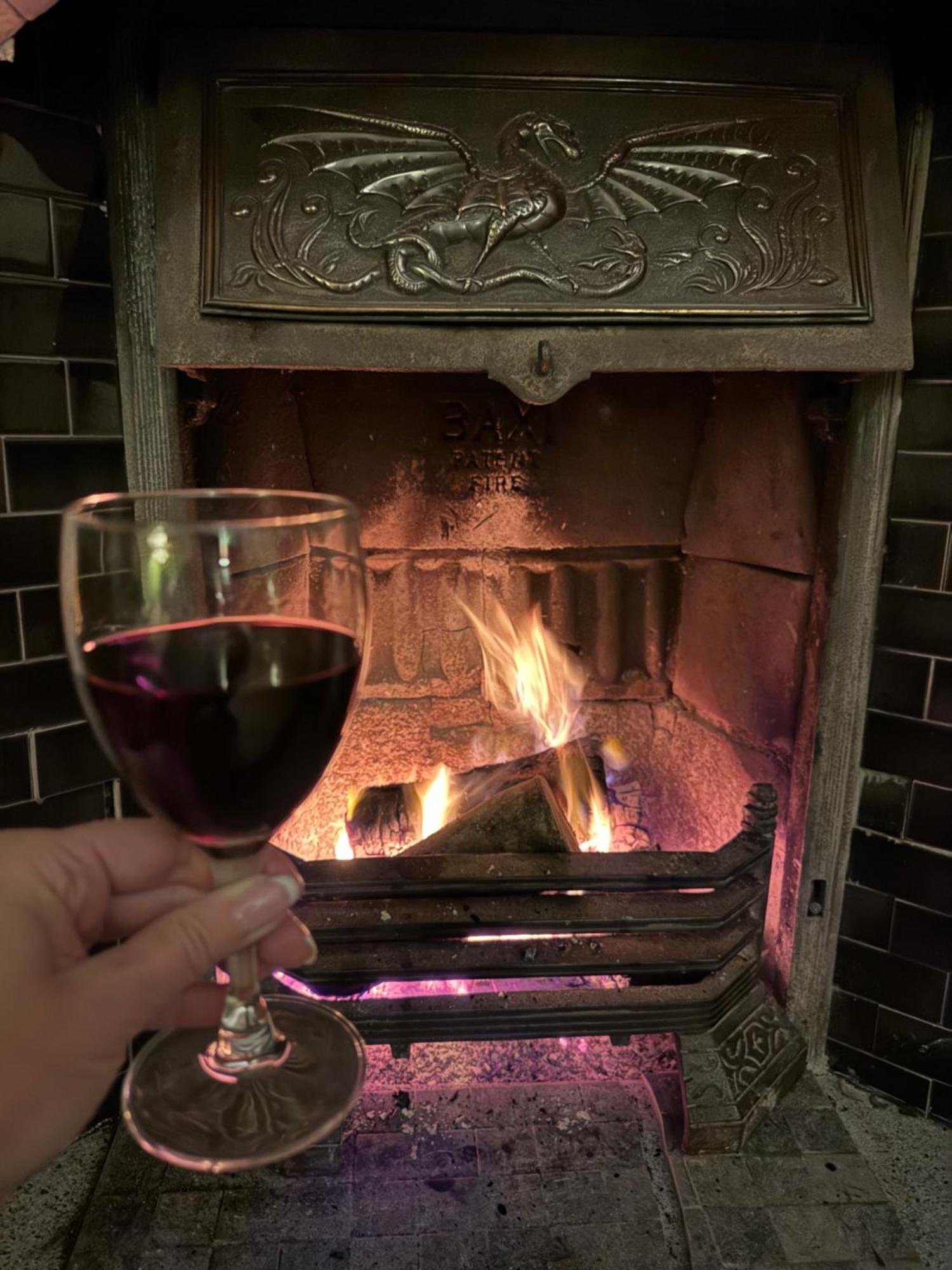 Clone Country House Aughrim Exterior photo A glass of red wine in front of a fireplace
